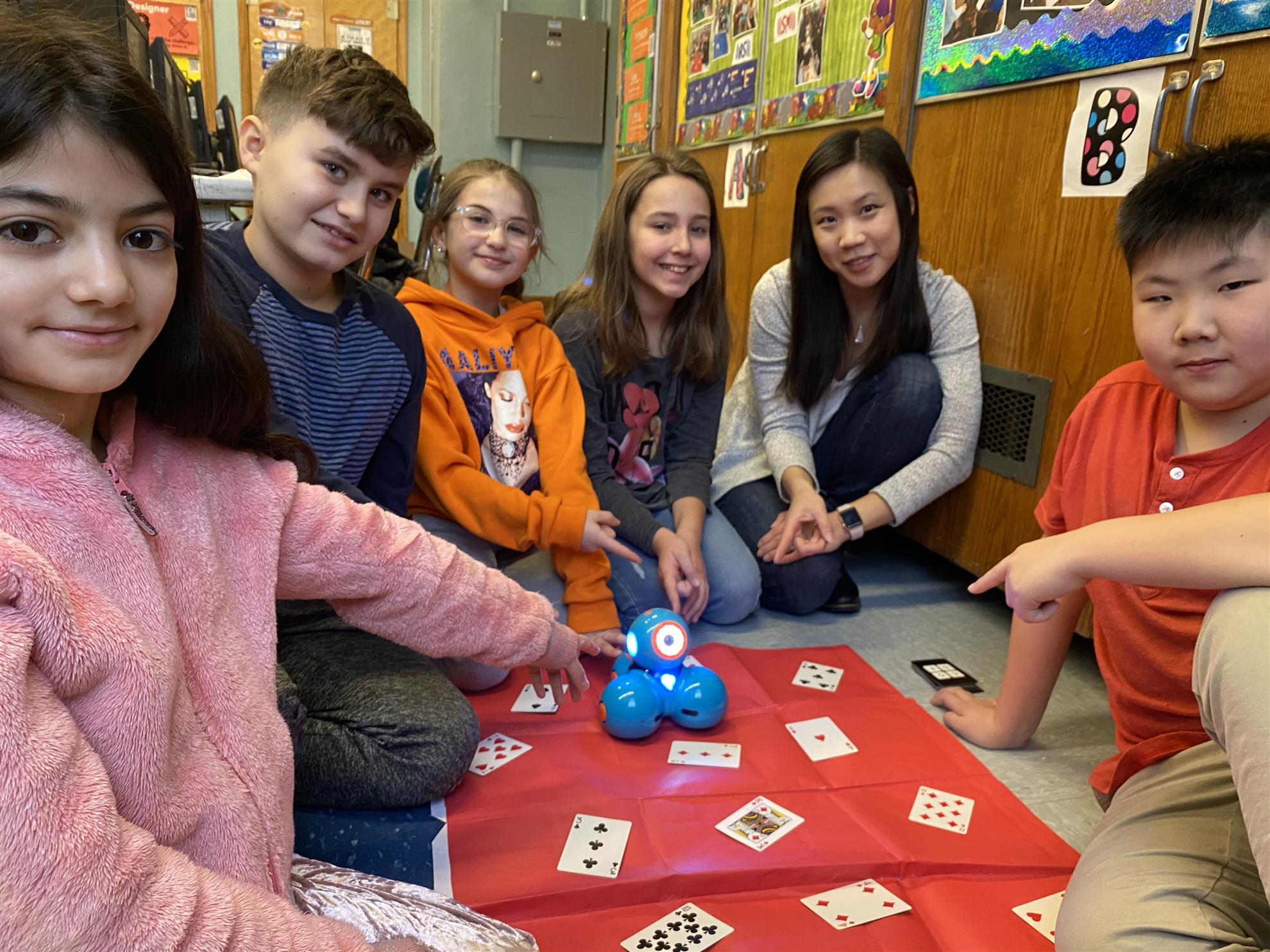 Cindy Wong and her students engaging with a robot