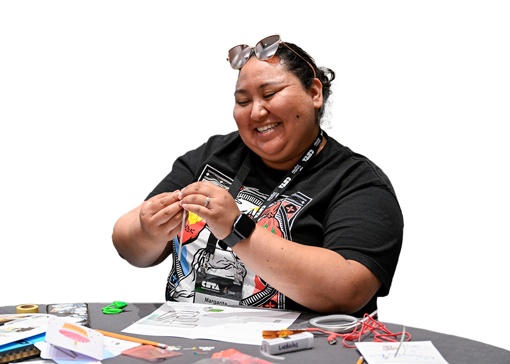 Woman smiling while completing an activity during a conference session