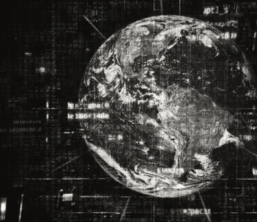 Black and white image of the earth with code over it