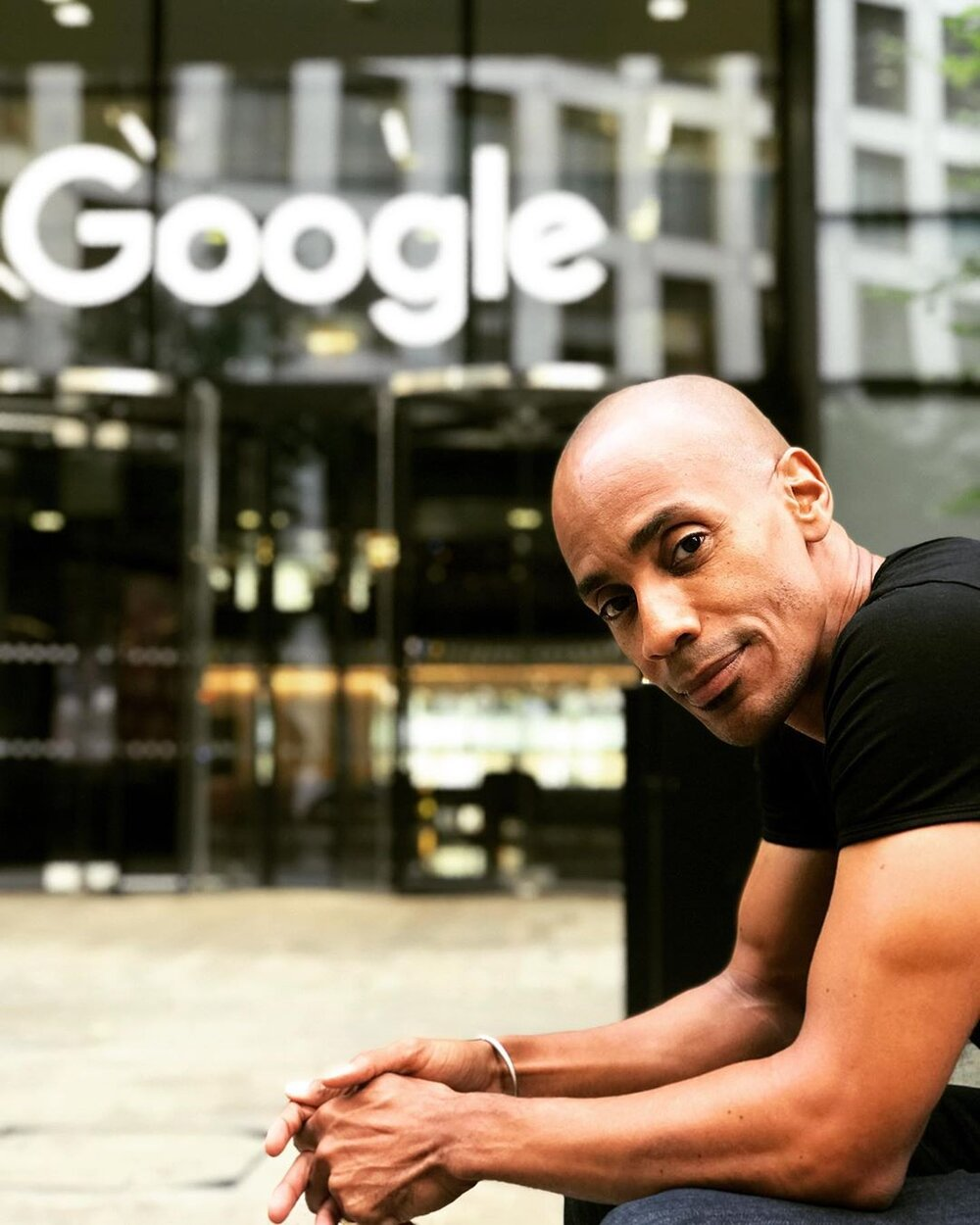 Headshot of 2021 Equity in Action Summit closing keynote speaker Dr. Kamau Bobb sitting outside Google headquarters