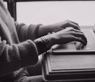 Close up of hands typing on a laptop