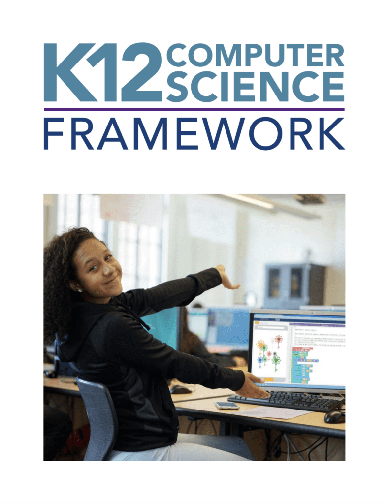 Student points proudly at their computer science assignment. text reads: "k-12 computer science framework."