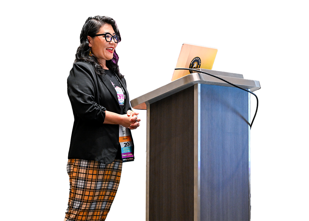 A woman speaking from a podium